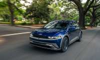 Blue 2026 Hyundai Ioniq 5 driving on a road with motion blur.