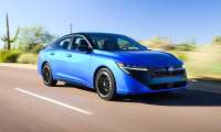 Blue 2026 Nissan Sentra SR driving on a sunny desert road.