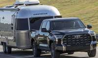 2026 Toyota Tundra confidently towing a trailer in a rural area.