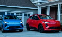 2027 Chevrolet Bolt EV, two of them, blue and red, parked in front of house