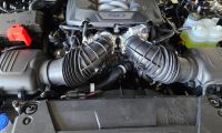 The engine area of a Ford Mustang GT shows off dual intakes