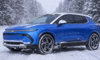 Blue 2025 Chevy Equinox EV on a cold winter road