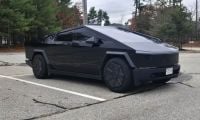 A Tesla Cybertruck looks menacing in a dark black glossy wrap