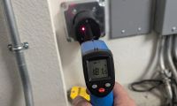 Infrared thermometer measuring 181 degrees on EV charger outlet showing heat buildup