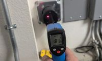 Infrared thermometer measuring 181 degrees on EV charger outlet showing heat buildup