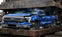 Blue Ford F-150 Lightning in a car crusher