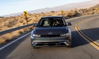 Hyundai Ioniq 5 electric SUV front three quarter view driving on desert highway