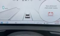 Vehicle dashboard display showing "Stop vehicle and check power supply" warning message with 0 MPH speed reading and battery icon, indicating electrical system issue.
