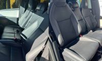Tesla Cybertruck custom interior with three front seats, black leather upholstery, and center front seat modification for large families