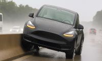 Picture of a Tesla Model Y on a highway concrete center divider