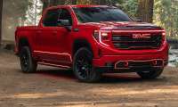 A 2026 Red GMC Sierra with custom headlights.