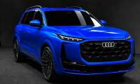 A blue Audi Q9 SUV shown from the front in a dark studio with illuminated Audi rings.
