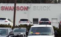 A Buick sign is removed from a Metro Boston dealership.