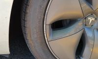 Tesla Model Y rim with scuffed paint from hitting a curb