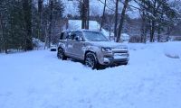 A 2026 Land Rover Defender 110 sits in a pile of snow