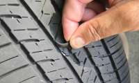 An original equipment tire is shown falling apart after just 12,000 miles