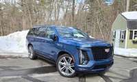 A 2026 Cadillac Escalade strikes a handsome pose in a wintery setting
