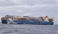 Image showing a firefighter boat attempting to put out the fires aboard the fire-ravaged Felicity Ace car carrier ship.