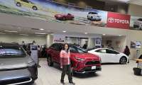 A shopper looks for good deals in a Toyota showroom