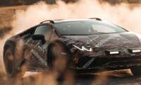 Image showing a Lamborghini Huracan Sterrato kicking up a huge cloud of dust while sliding sideways on a gravel road.