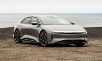 Silver Lucid Air parked near the ocean in a front three-quarter view.