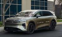 Lucid Gravity electric SUV mobile service vehicle parked outside a modern building