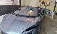 2025 McLaren Artura Spider charges on an Emporia Level 2 EV charger inside a lucky person's garage