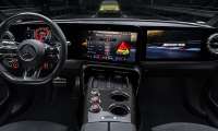 Mercedes-AMG performance cockpit with digital dashboard, AMG drive settings, carbon-fiber console, and sport steering wheel.