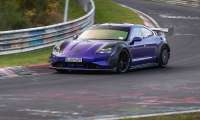 Purple Porsche Taycan Turbo GT with Manthey Kit cornering on the Nürburgring track.