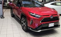 A Toyota RAV4 Plug-In is shown on display in a dealer showroom
