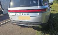 Rear view of Mike's Rivian R1S showing minor bumper damage after being struck from behind on the highway.
