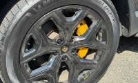 Close-up of a Rivian R1T wheel with Michelin Pilot Sport S5 tire and yellow brake caliper.