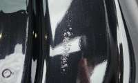 A Tesla Model Y with a paint defect is shown