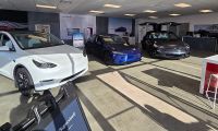 A Tesla dealership in Peabody Massachusetts has many cars on the showroom floor