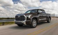 2024 Toyota Tundra 1794 Edition in smoked mesquite driving on highway with cloudy sky