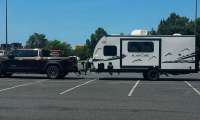 Toyota Tundra hitched to a Cherokee Black Label travel trailer in a parking lot