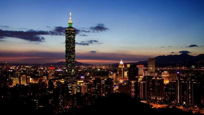 Image showing the skyline of Taipei, Taiwan lit up at sunset.