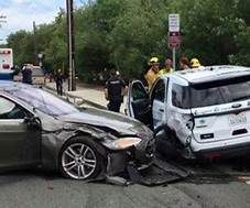 Tesla Crumpled Near Rumpled Police Car