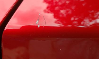 Repairing special Mazda paint with touch-up kit.